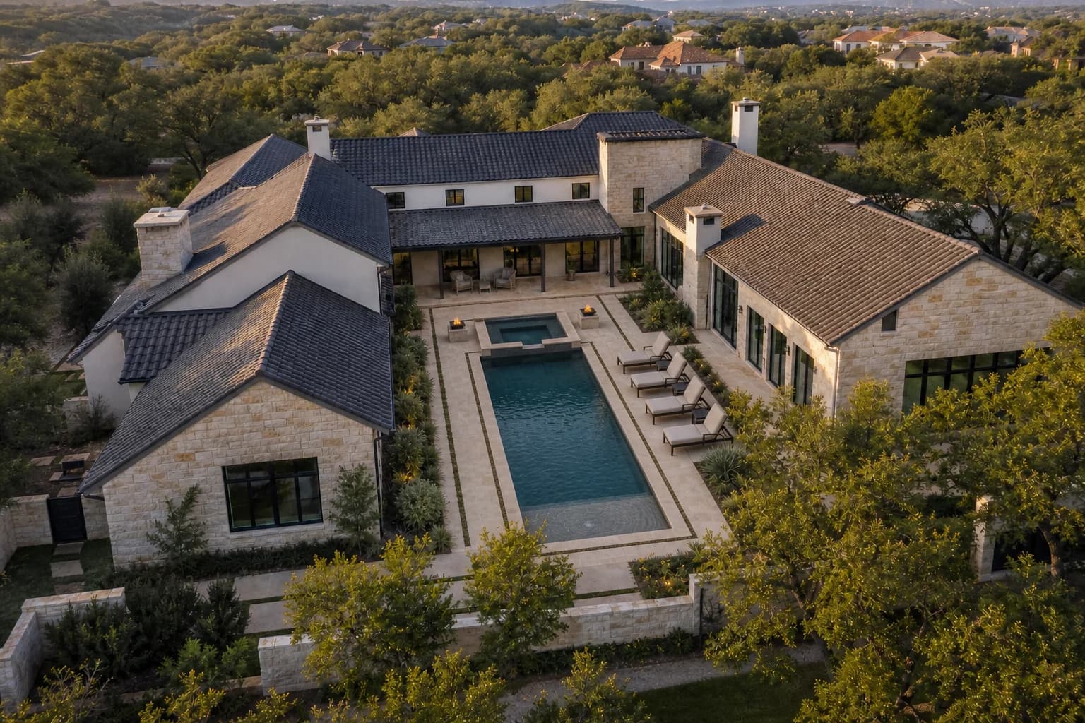 Courtyard estate with a linear pool, spa and limestone deck concept